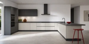 Modern fitted kitchen with a clean worktop and red accent.