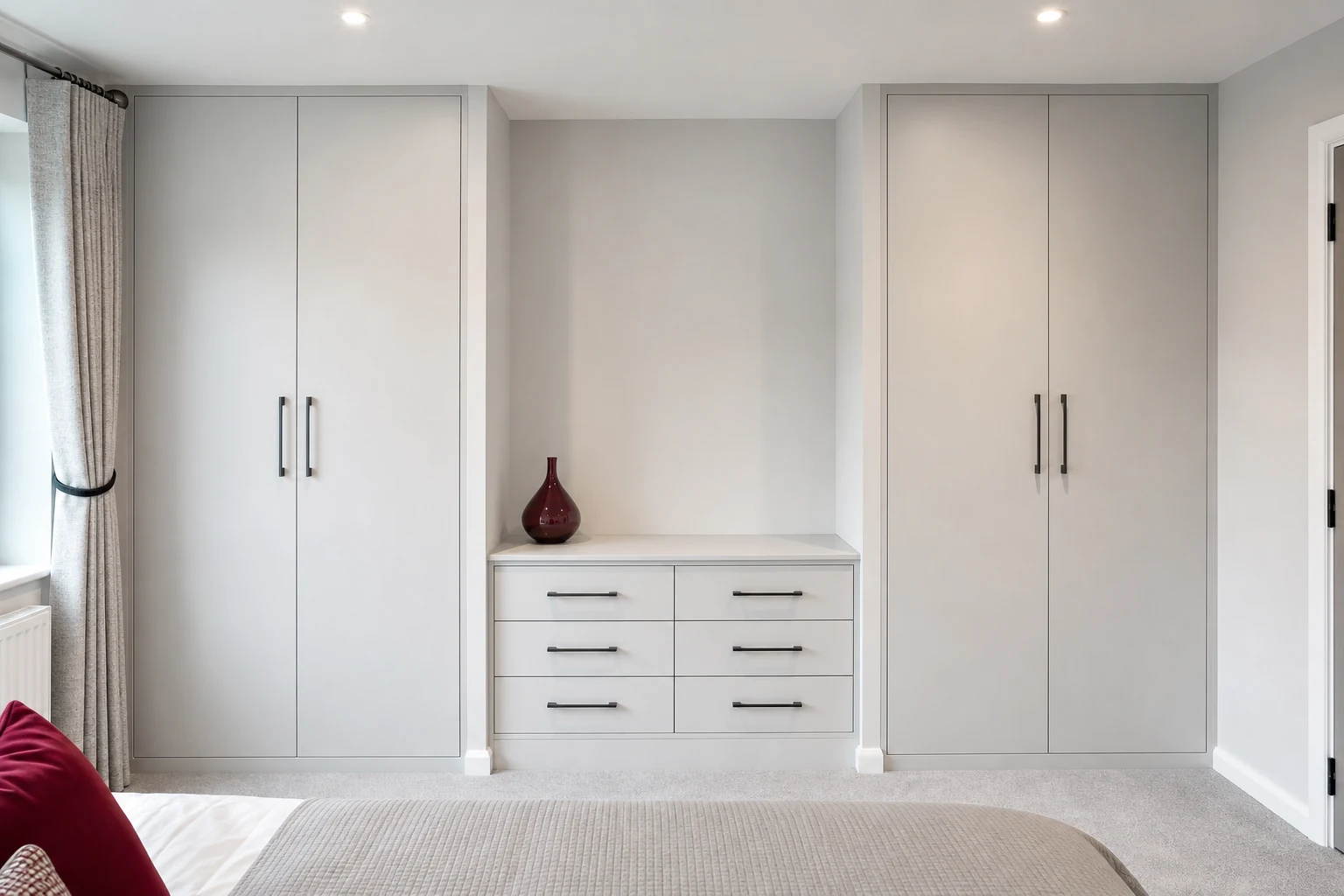 Built-in bedroom storage fitted cleanly into wall alcoves.