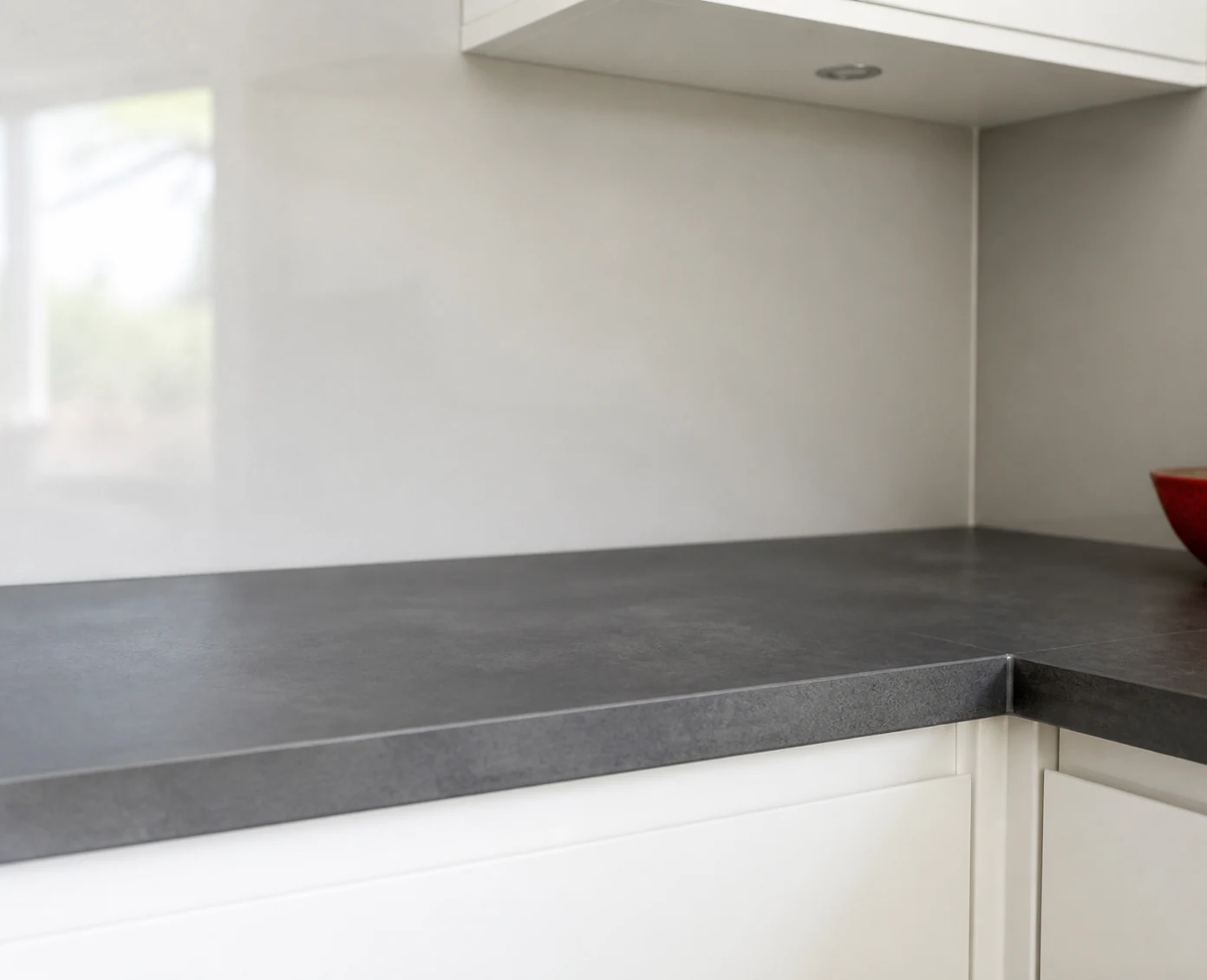 Neat kitchen worktop join and clean finished splashback edge